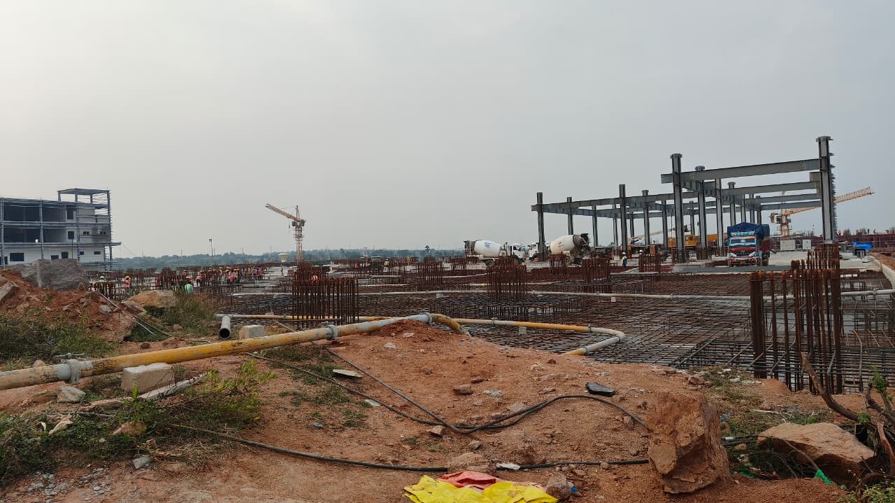 Construction site with rebar and cranes
